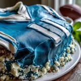 Creative sports jersey cake decorated with personalized numbers and name, perfect for a graduation party dessert table.  