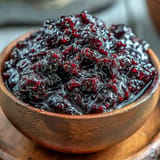 Homemade Blackberry Jalapeño BBQ Sauce glistening, perfect for grilling any meat.