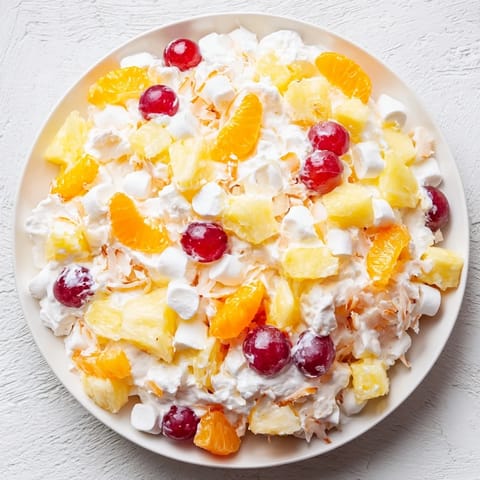 This refreshing Ambrosia Salad highlights sweet fruit chunks mixed in a creamy, chilled dessert.