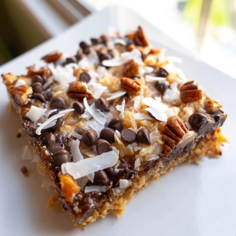 Chewy and sweet Magic Cookie Bars, showing off their perfect, layered texture and inviting aroma.