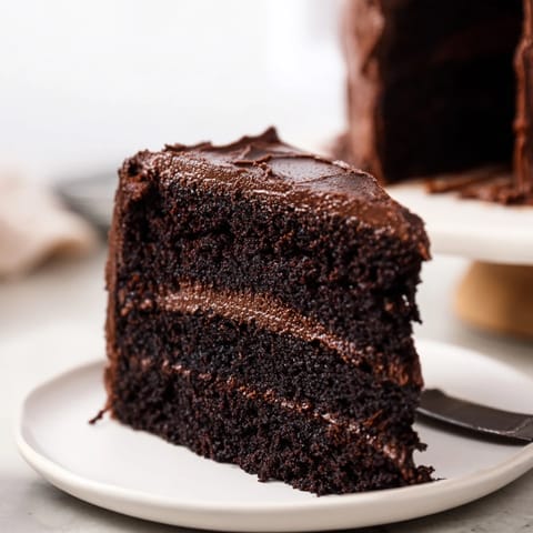 A towering slice of Devil's Food Cake: a decadent dessert, perfect for any special occasion.