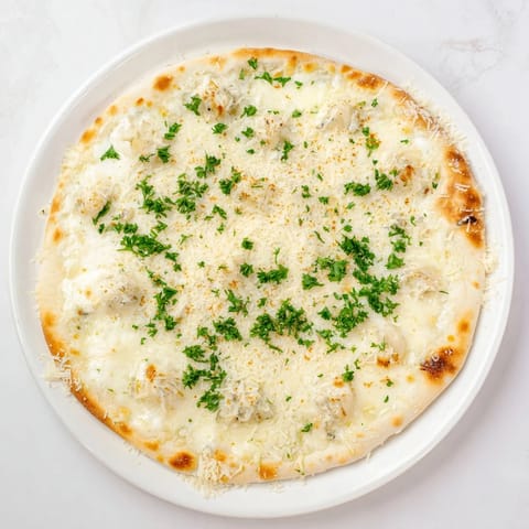 A rustic Creamy Garlic White Pizza slice with velvety garlic sauce and melted cheese, served on a wooden board.