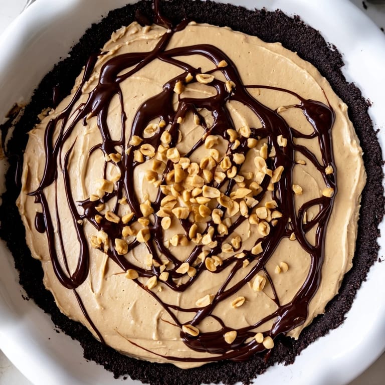Enjoy a decadent slice of this easy-to-make Peanut Butter Pie, topped with chocolate.
